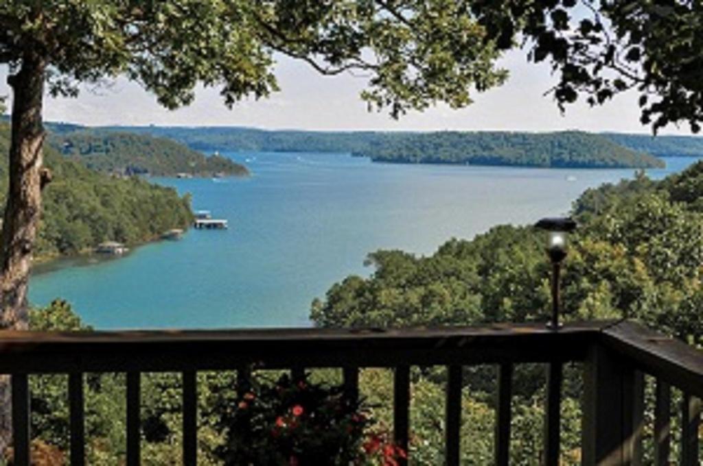 a view of a lake from the deck of a house at Beaver Lake Cottages in Eureka Springs