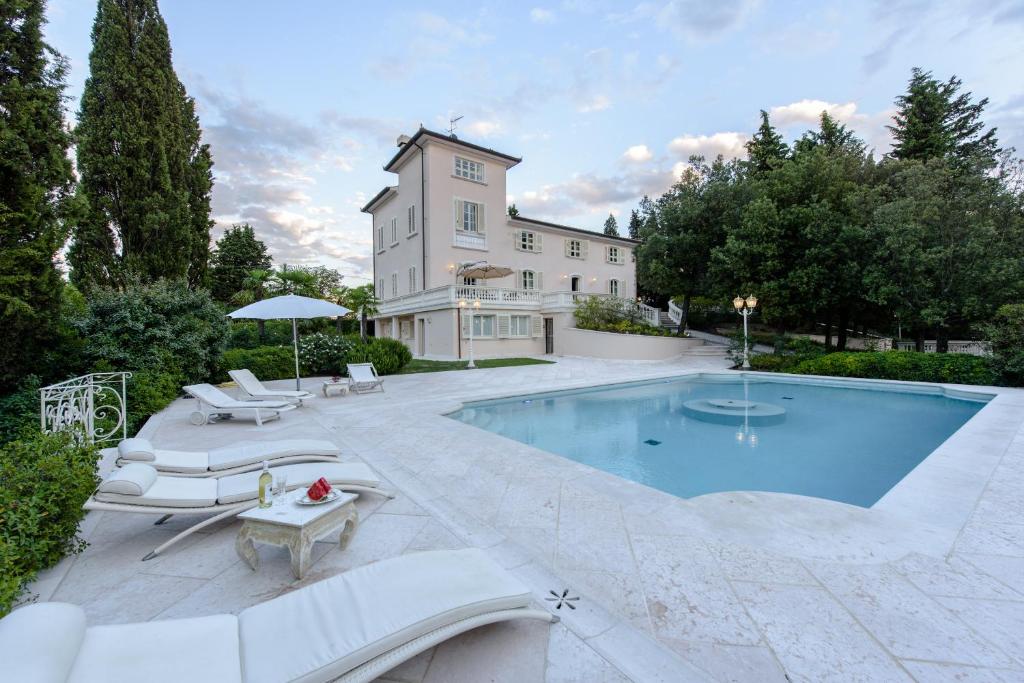 a house with a swimming pool in front of a house at Villa Rinaldi in Montespertoli