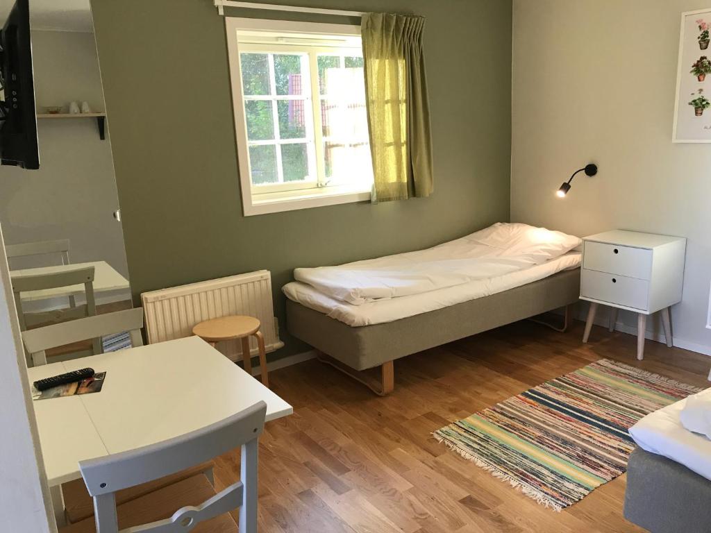Postel nebo postele na pokoji v ubytování Sandvikengården Stugby