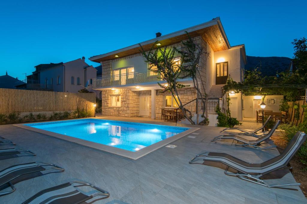 una piscina di fronte a una casa di Holiday Home Costa a Orebić (Sabbioncello)