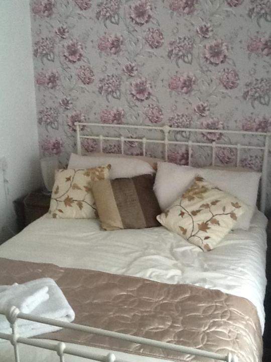 a bed with white sheets and pillows in a bedroom at No 16 The Hub Abercrave in Swansea