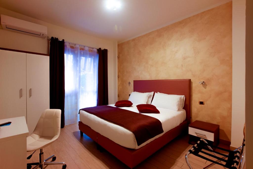 ローマにあるRome By Suite Vaticanのベッドとデスクが備わるホテルルームです。