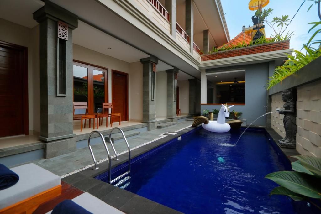 a swimming pool in the backyard of a house at Singgah Hotel Seminyak in Seminyak