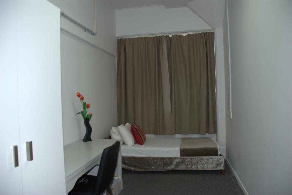 Postel nebo postele na pokoji v ubytování Hamilton City Inn
