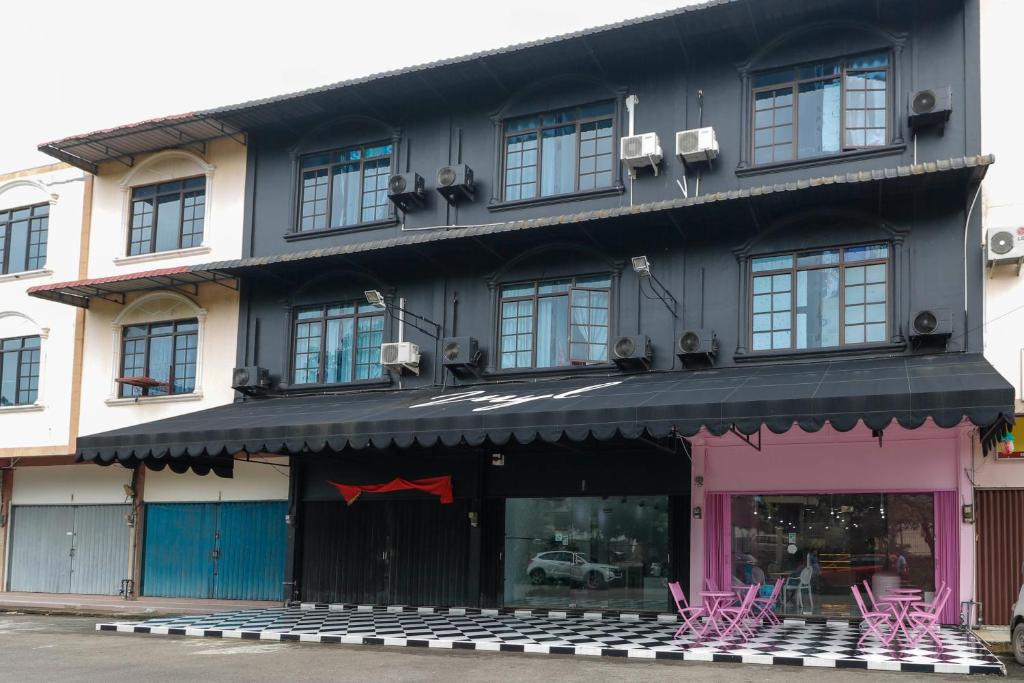 a store with pink chairs in front of a building at RedDoorz Plus near Batam City Square in Batam Center