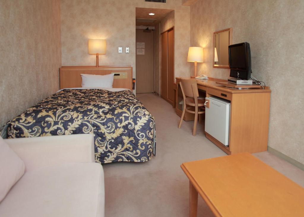 Postel nebo postele na pokoji v ubytování Saku Grand Hotel
