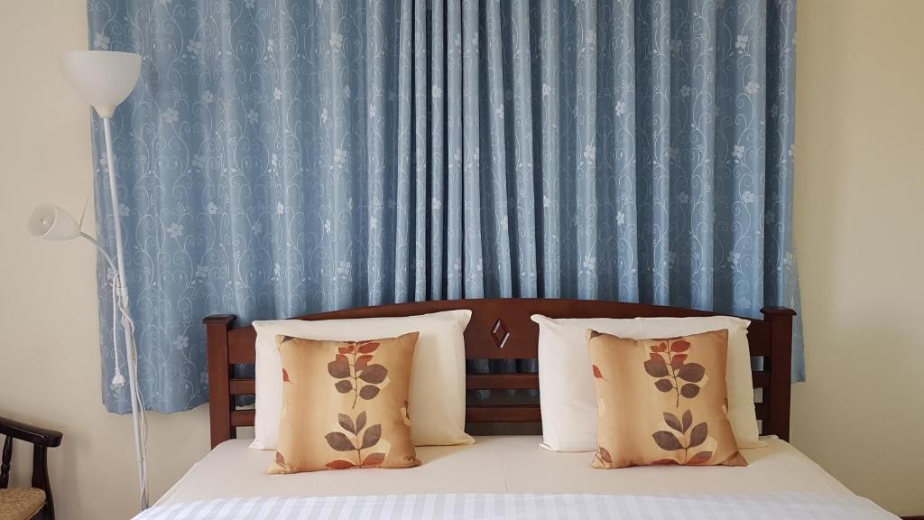 Postel nebo postele na pokoji v ubytování Baan Taweesuk Guest House