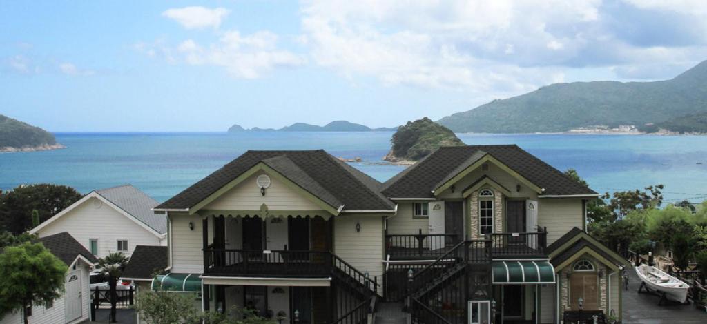 a large house with a view of the ocean at Seommaeul Pension in Geoje 