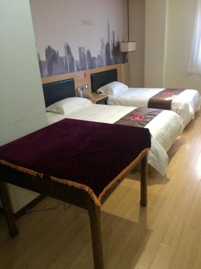 Postel nebo postele na pokoji v ubytování JUNYI Hotel Jiangsu Nanjing University of Information Science and Technology