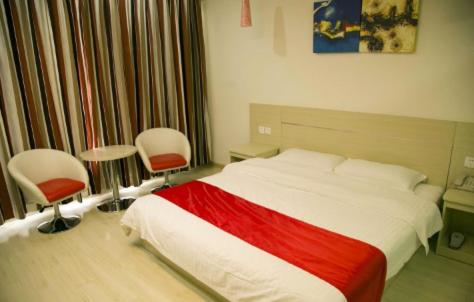 Кровать или кровати в номере Thank Inn Chain Hotel Jiangsu Yancheng Dafeng City North Renming Road