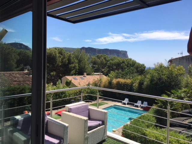 a balcony with a view of a swimming pool at Villa W in Cassis