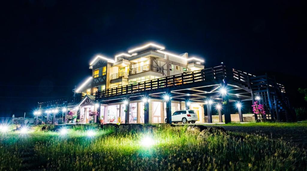 a building with lights in front of it at night at Fully One B&amp;B in Taitung City