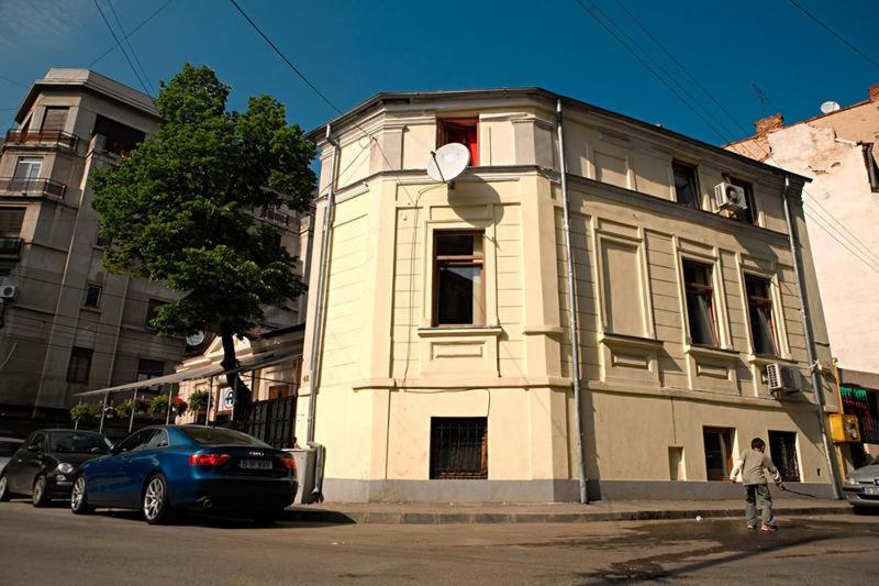 a white building on the corner of a street at Fun House in Bucharest
