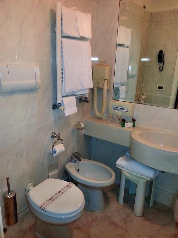 a bathroom with a sink and a toilet and a mirror at Albergo Cavalletto &amp; Doge Orseolo in Venice