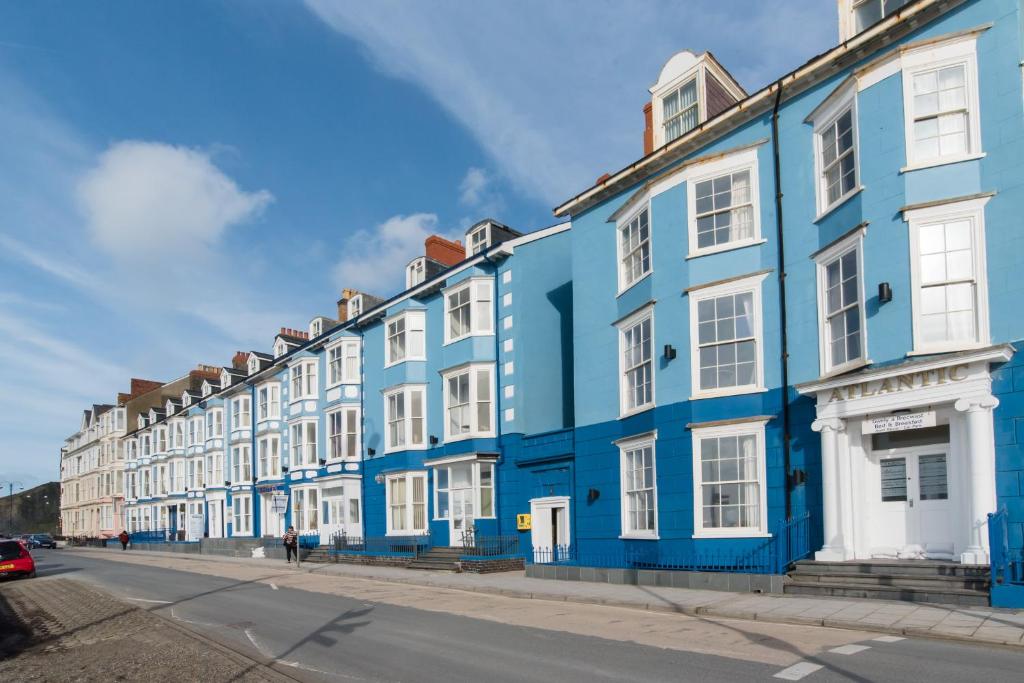 a row of blue and white buildings on a street at Marine Studios in Aberystwyth