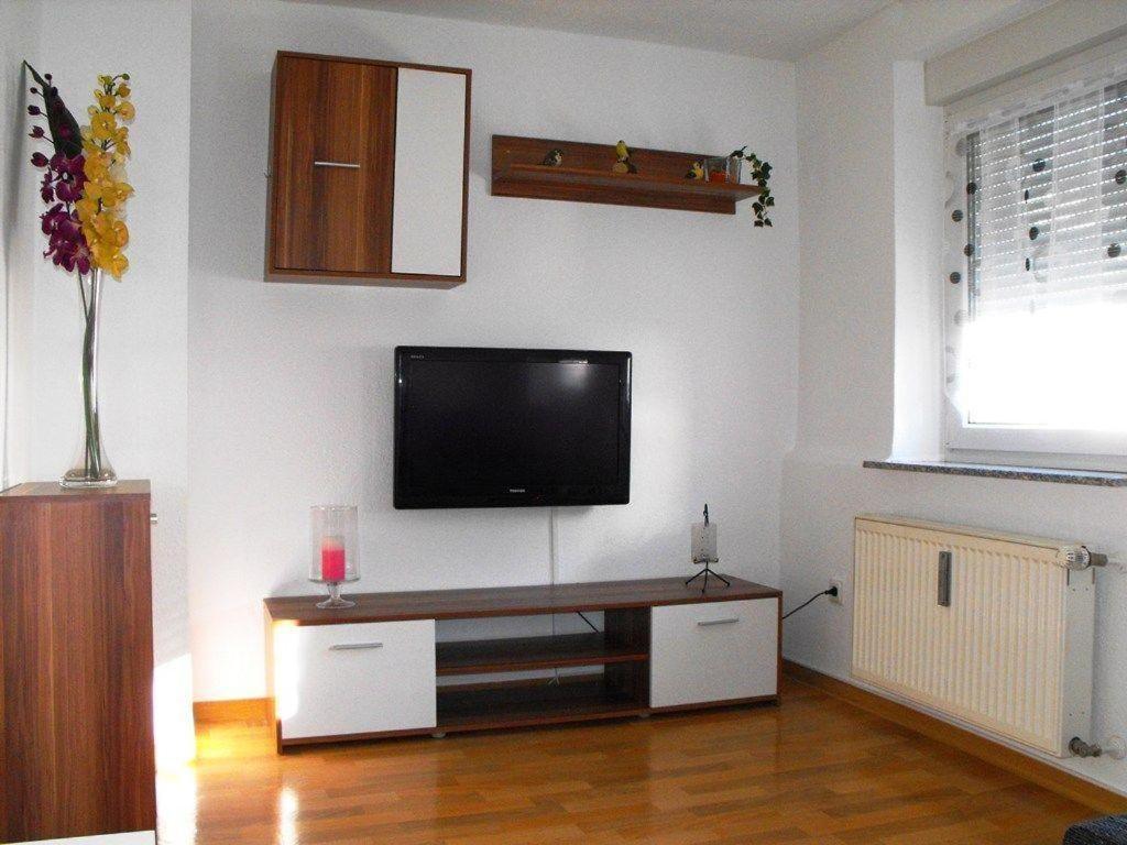 a living room with a flat screen tv on a wall at Ferienwohnung-Thielen-Waldrach-Ruwertal in Waldrach