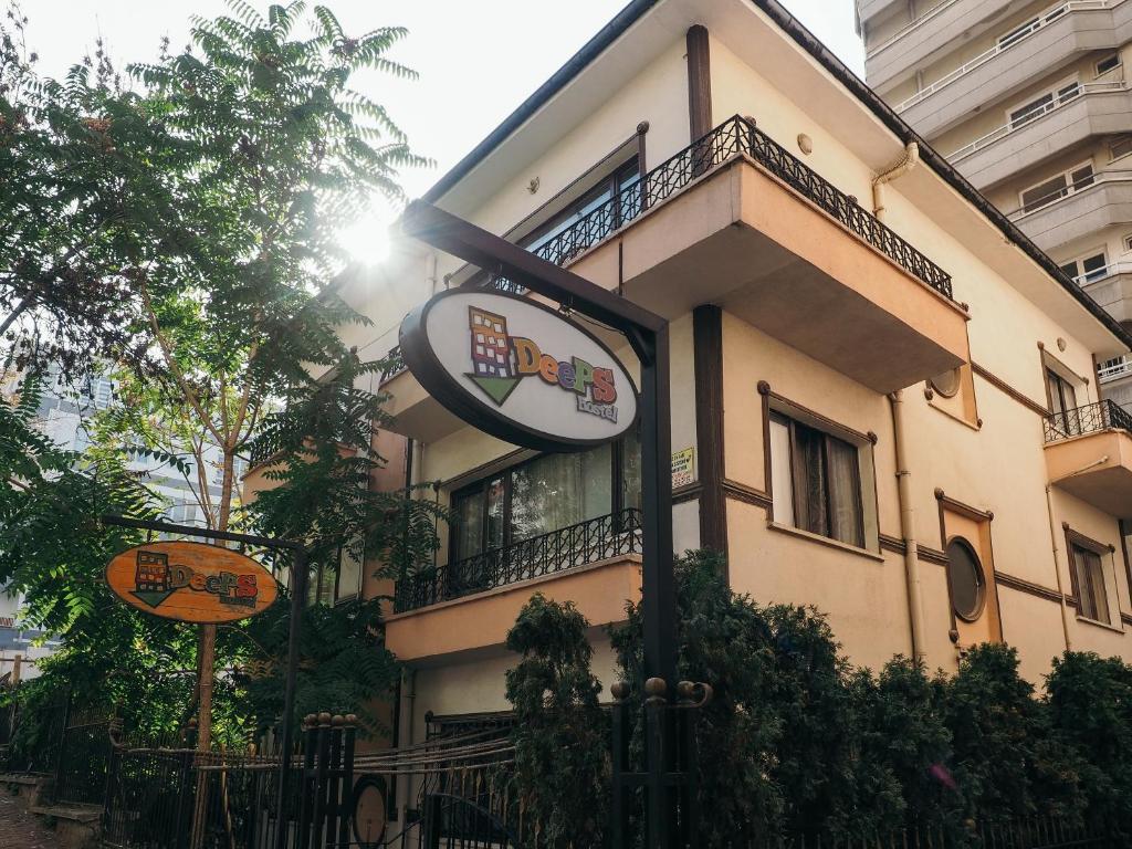 a building with a sign in front of it at Deeps Hostel Ankara in Ankara