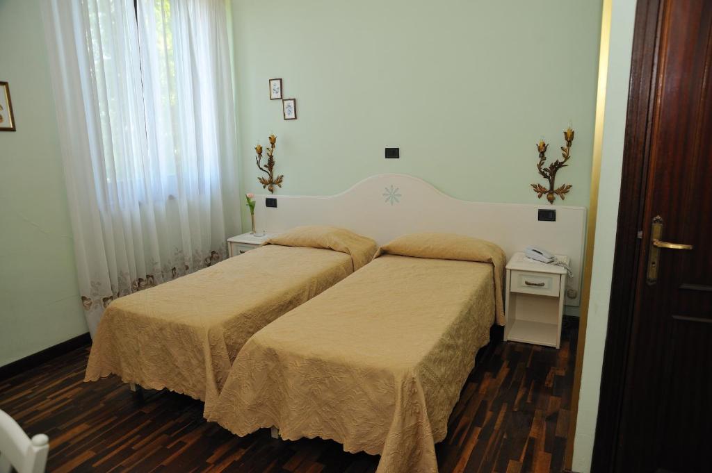 Postel nebo postele na pokoji v ubytování Hotel Savona