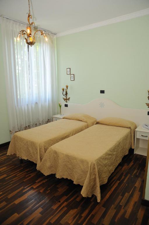 Postel nebo postele na pokoji v ubytování Hotel Savona