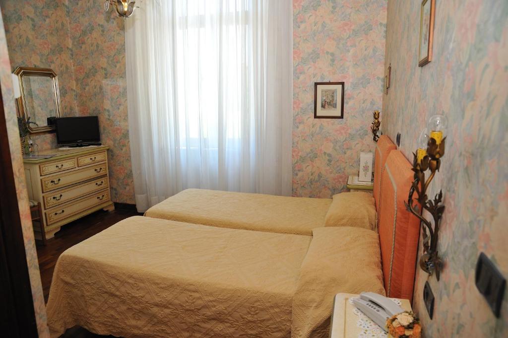 Postel nebo postele na pokoji v ubytování Hotel Savona