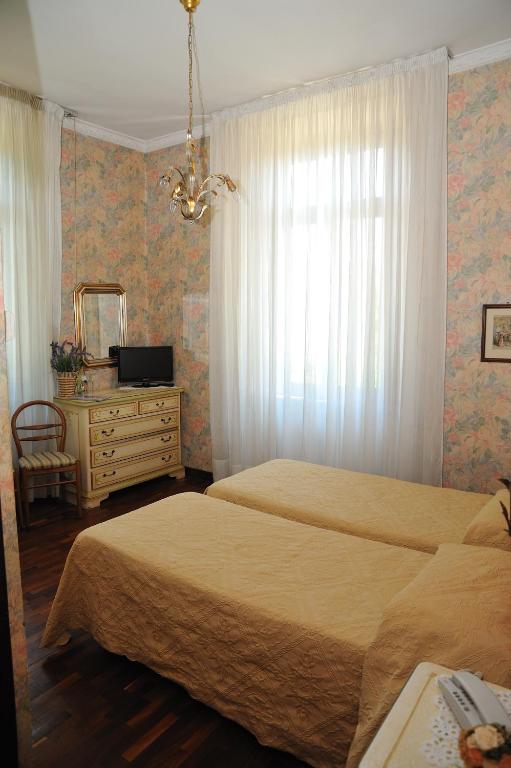 Postel nebo postele na pokoji v ubytování Hotel Savona