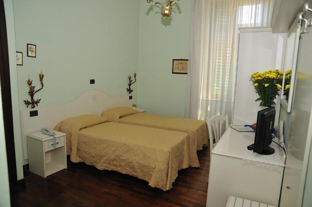 Postel nebo postele na pokoji v ubytování Hotel Savona