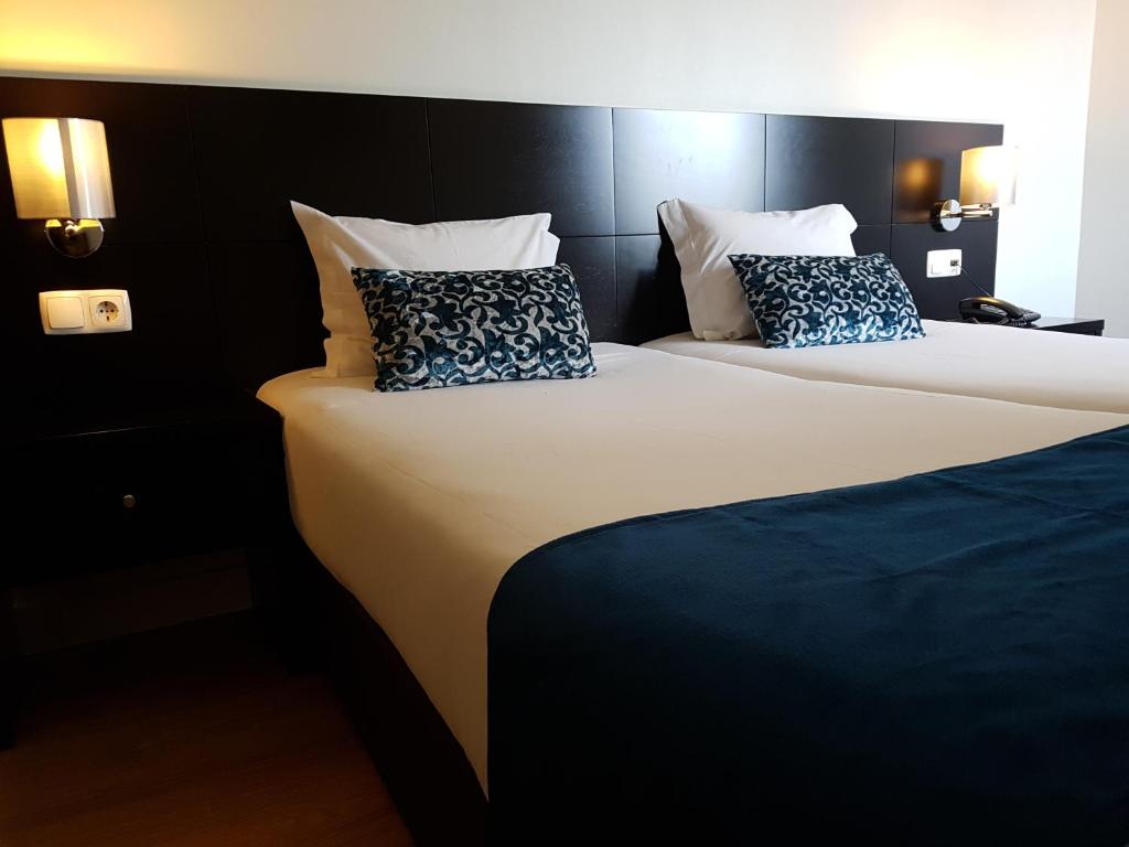 A bed or beds in a room at Lisbon City Hotel by City Hotels