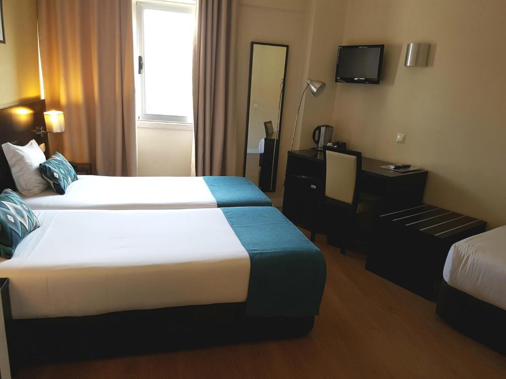 A bed or beds in a room at Lisbon City Hotel by City Hotels