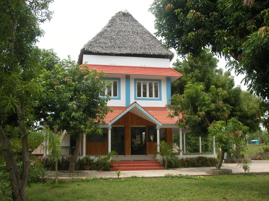 a small house with a gambrel roof at Prince Park in Puducherry