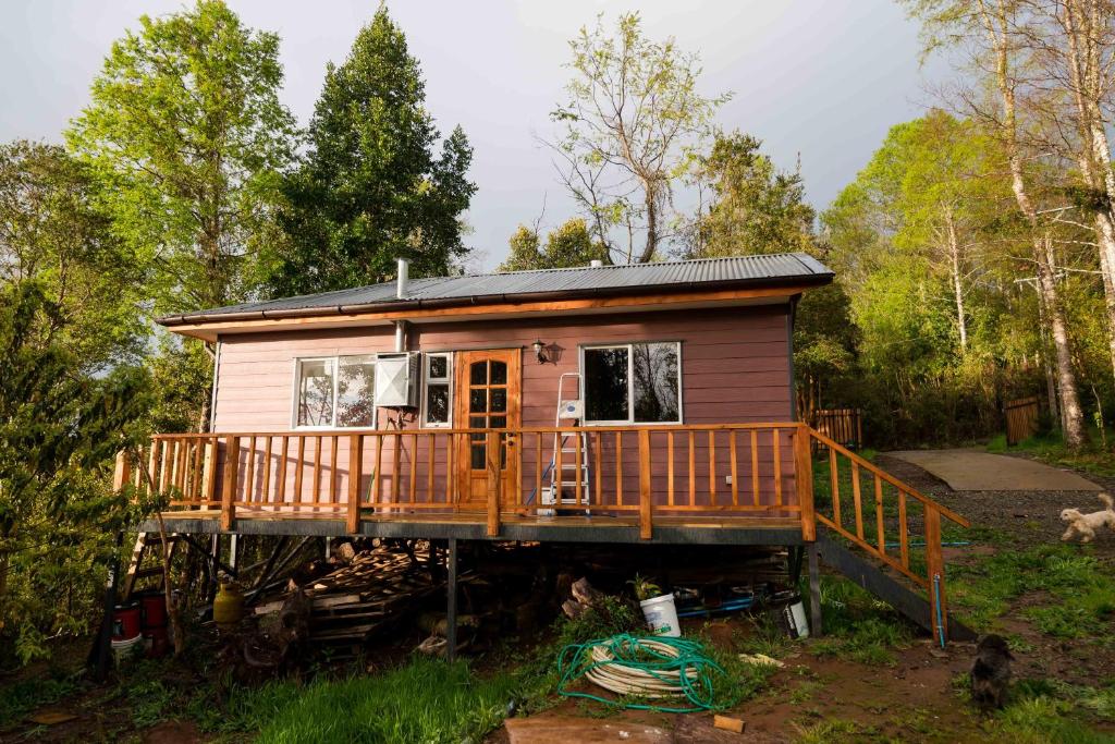 una casa pequeña sentada en un montón de madera en Casa Arrayan Alto, en Valdivia