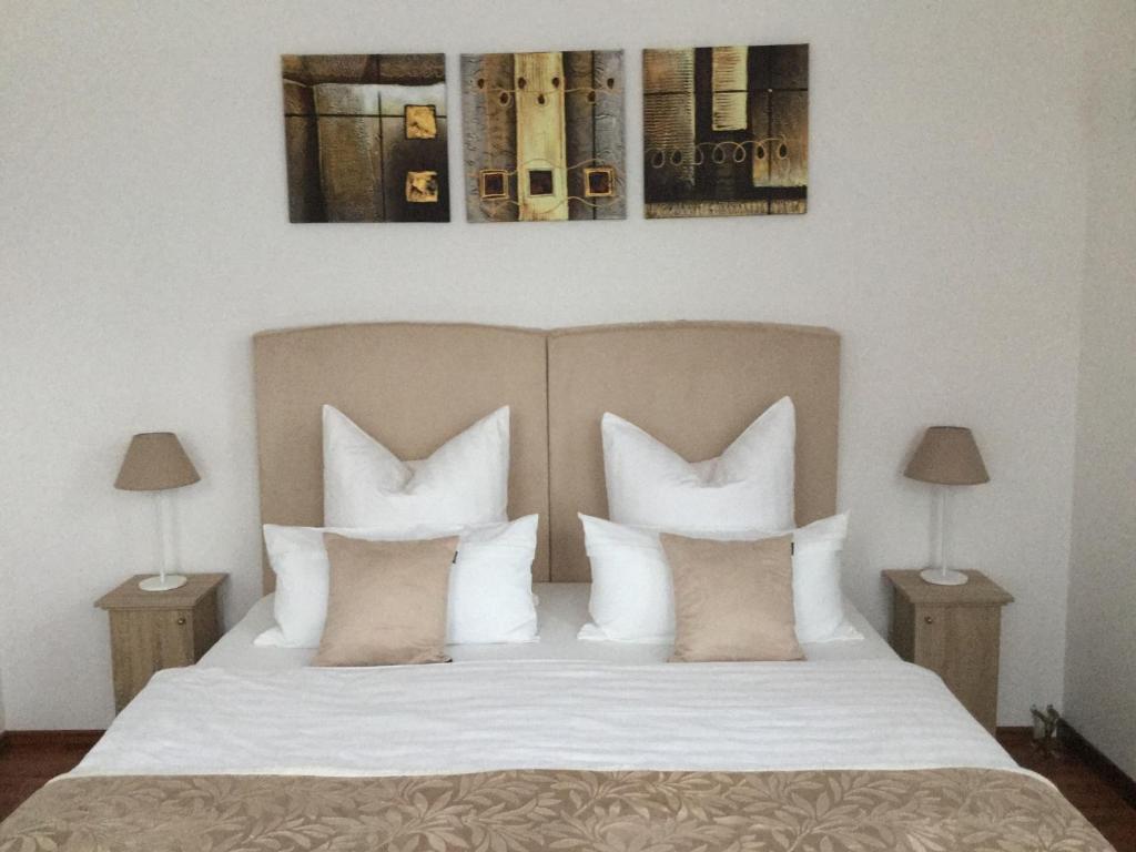 a bedroom with a white bed with pillows at feelgood Apartments - Apartment Chic in Braunschweig