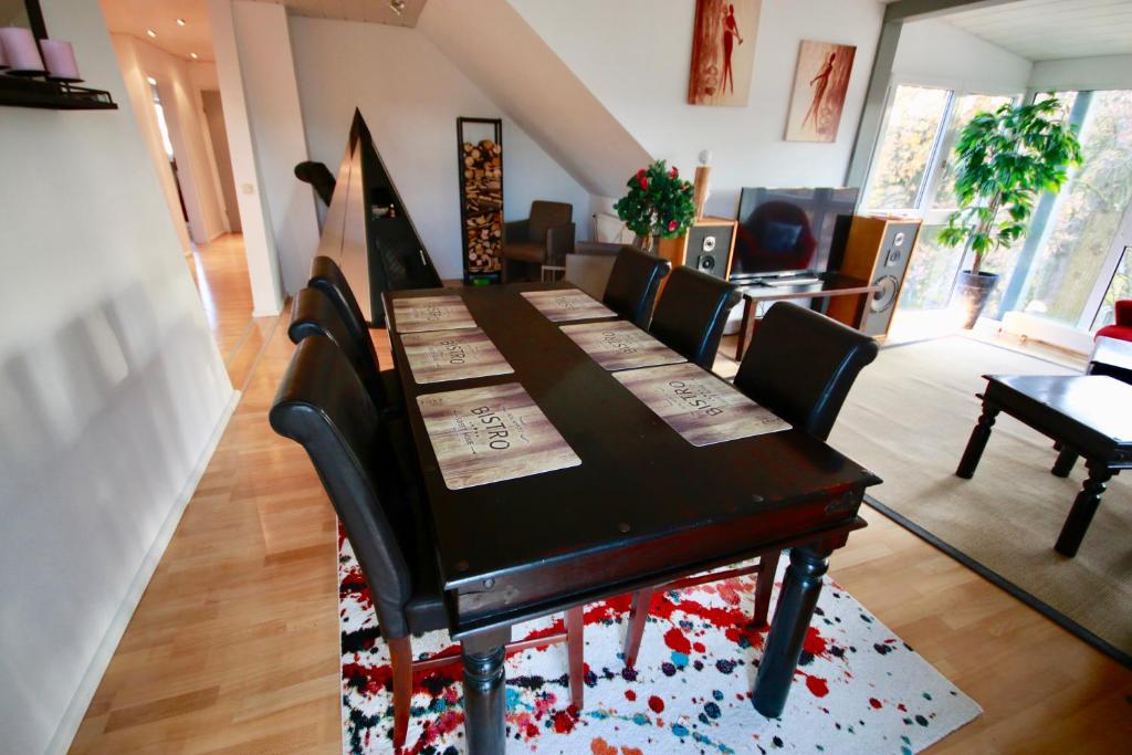 a dining room with a wooden table and chairs at Appartment Döllinger Messe Fränkisches Seenland in Schwabach