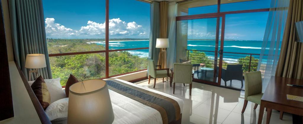 a bedroom with a bed and a view of the ocean at Sooriya Resort & Spa in Tangalle