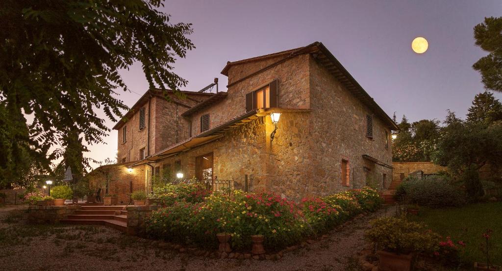 an old stone building with a moon in the sky at Agriturismo Il Colombaiolo in Pienza