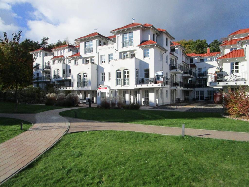 a large white building with a walkway in front of it at Haus Meeresblick Wohnung A 1.04 in Baabe