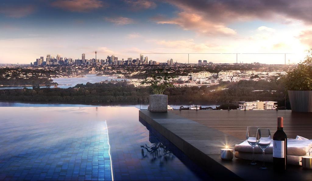 a swimming pool with a view of a city at Wentworth Point Oversized balcony view apartment in Sydney