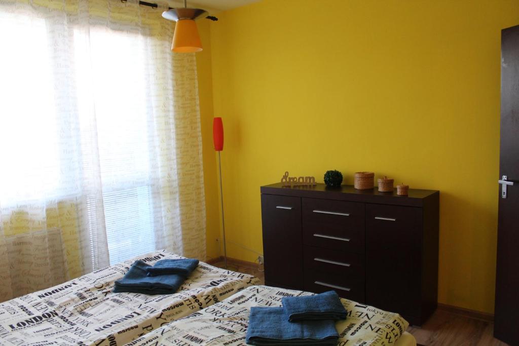 a bedroom with two beds and a dresser and a window at Apartman David in Štôla
