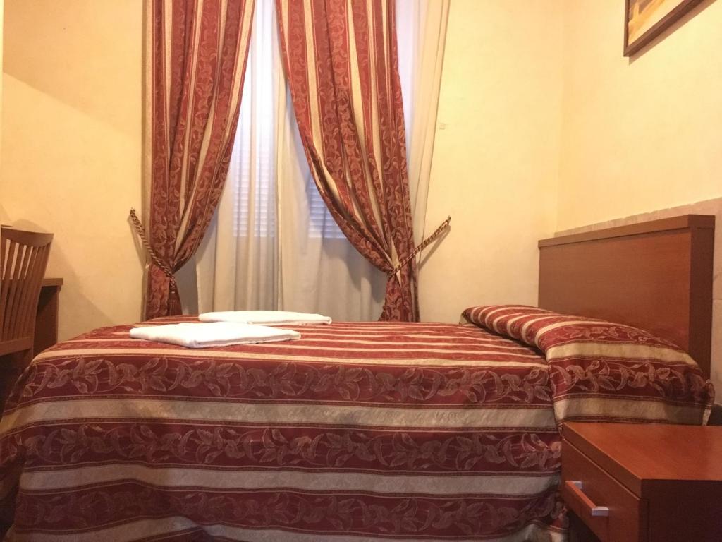 Postel nebo postele na pokoji v ubytování Toffa Place In Rome