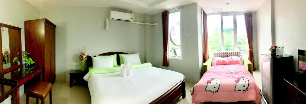 Postel nebo postele na pokoji v ubytování J.Holiday Inn Krabi