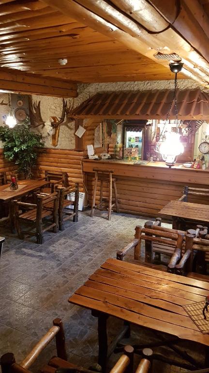 a restaurant with wooden tables and a bar at Hostel P33 in Tallinn