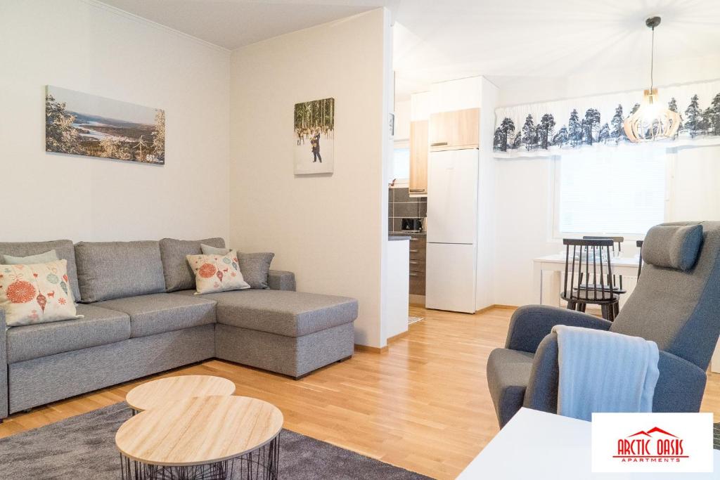 a living room with a couch and a table at Arctic Oasis Apartments in Rovaniemi