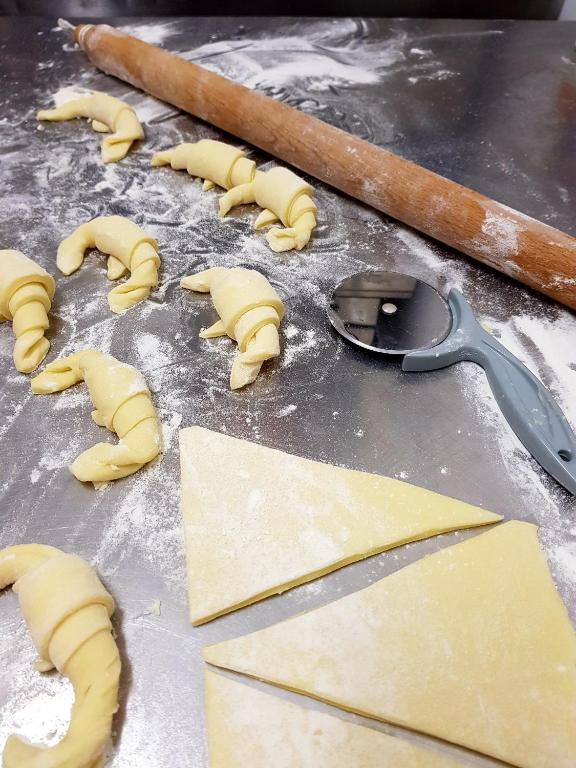 a bunch of uncooked dough on a table with a measuring spoon at Hotel Aurora Duino in Duino