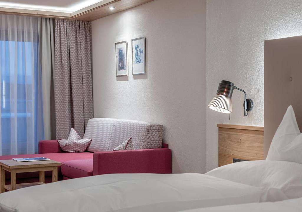 Postel nebo postele na pokoji v ubytování Hotel Alpenland