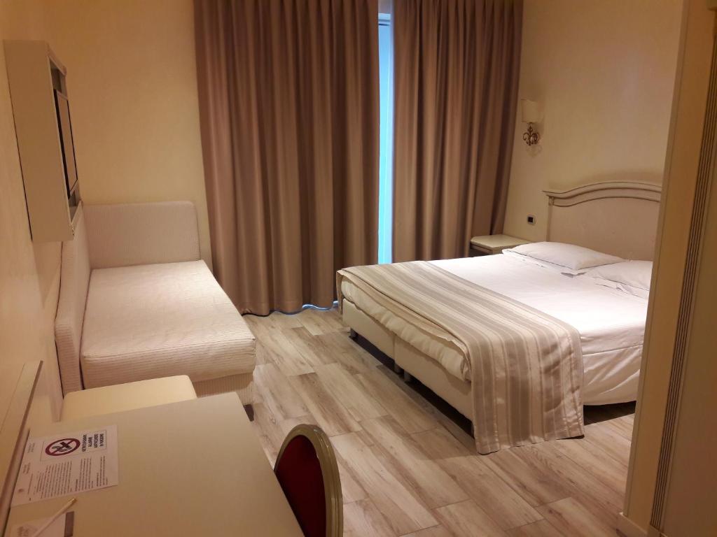 Llit o llits en una habitació de Palace Hotel & SPA La CONCHIGLIA D' ORO