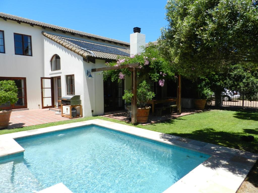 a swimming pool in the yard of a house at Sunset at Diluta in Cape Town