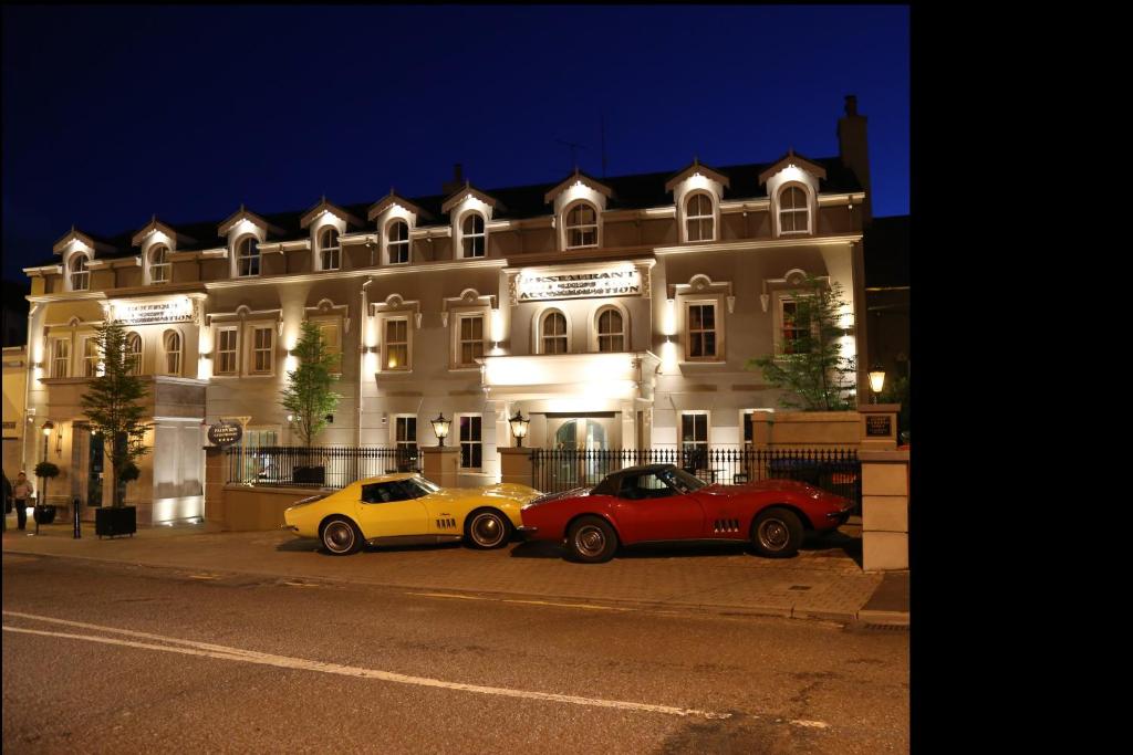 due auto parcheggiate di notte davanti a un edificio di The Fairview Boutique Hotel a Killarney