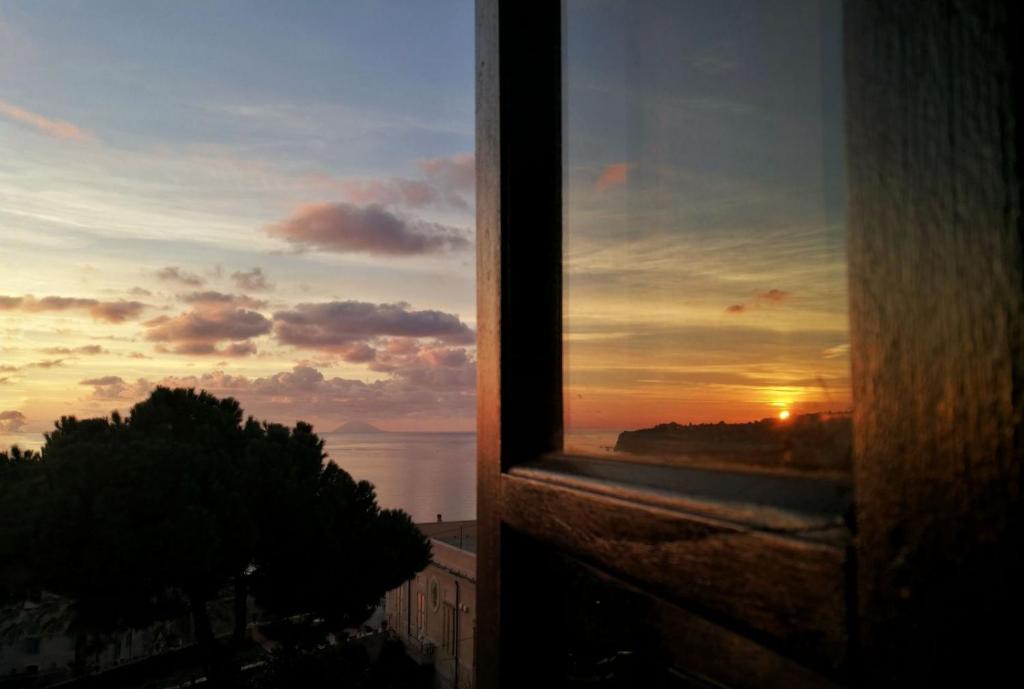 a view from a window of a sunset at B&B Rivellini in Tropea