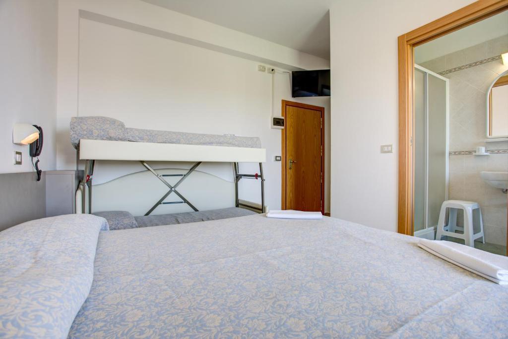Posteľ alebo postele v izbe v ubytovaní Hotel Amedea