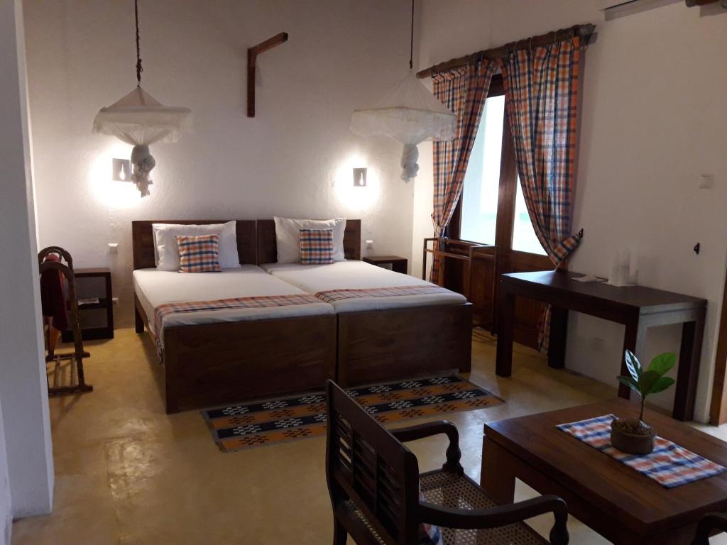 Postel nebo postele na pokoji v ubytování Muthumuni Ayurveda Beach Resort