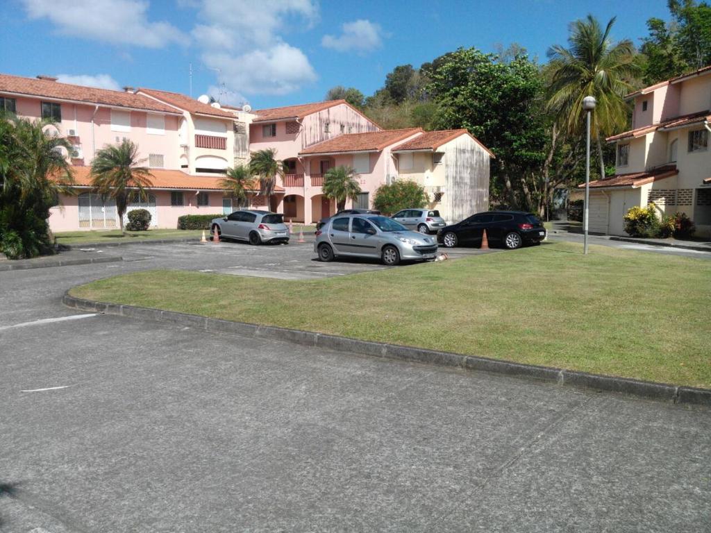 a group of cars parked in a parking lot at Madiana plage in Schœlcher